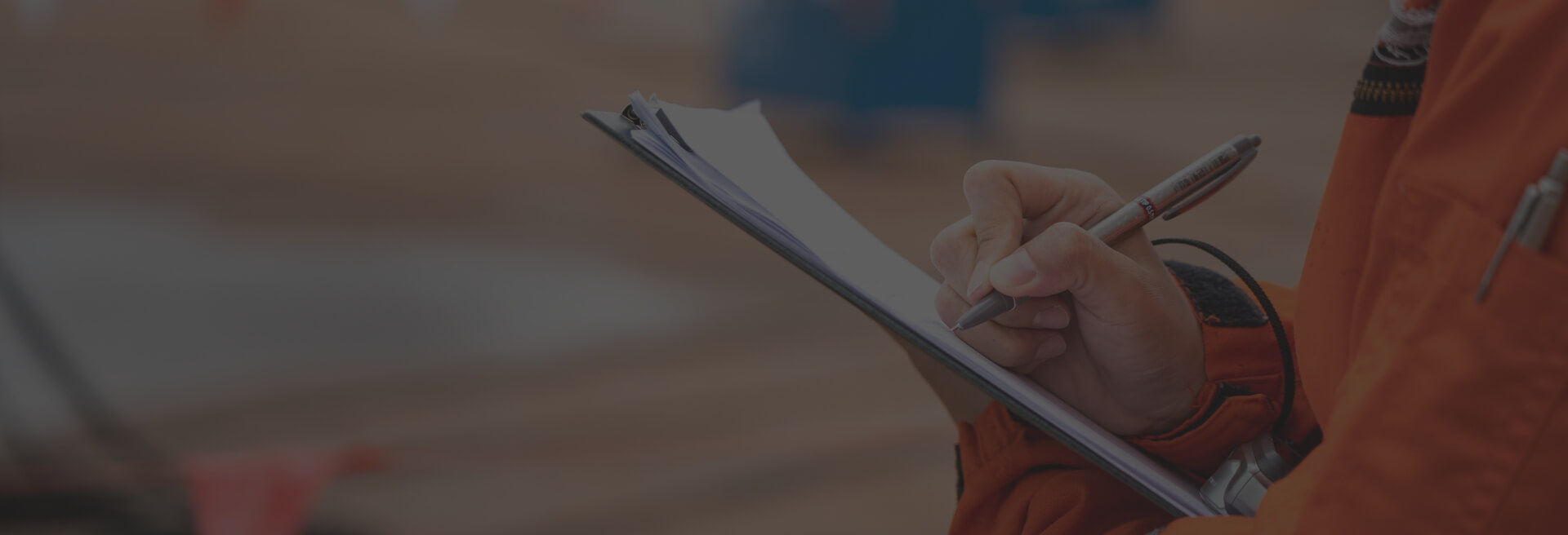 Men holding a clip board and writing something